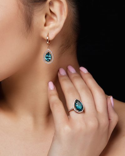 Model shows earrings and ring with beautiful blue precious stones